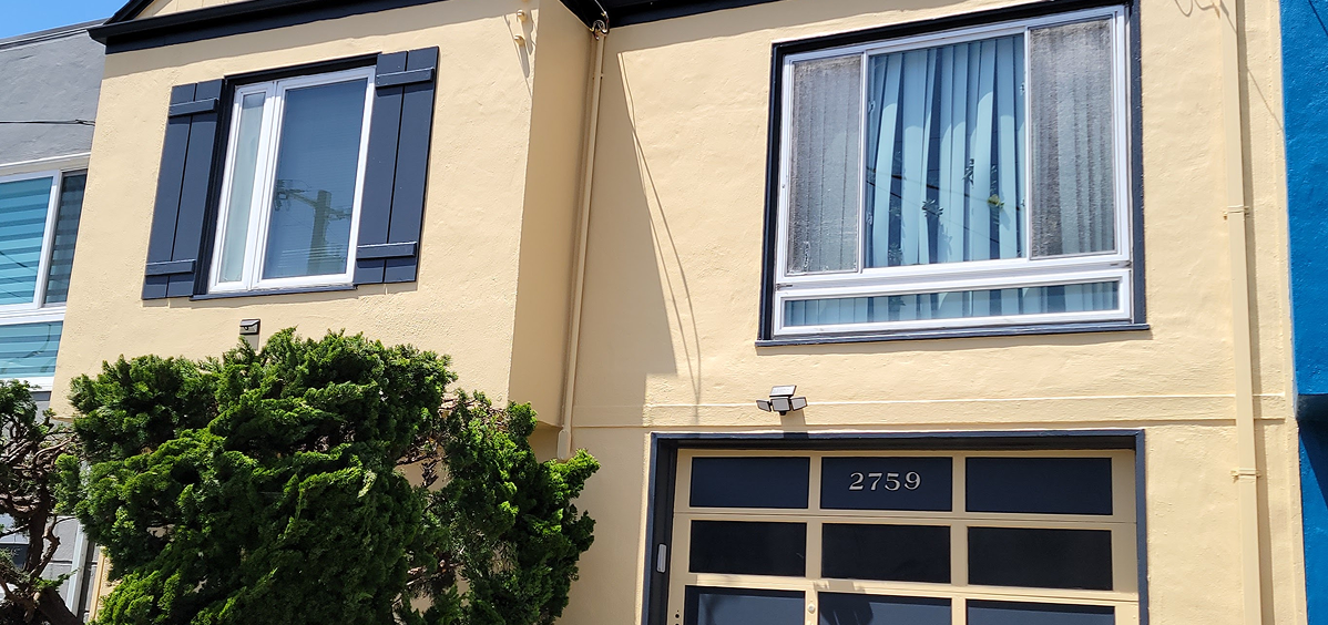 A beige building facade with windows and a garage door numbered 2739.