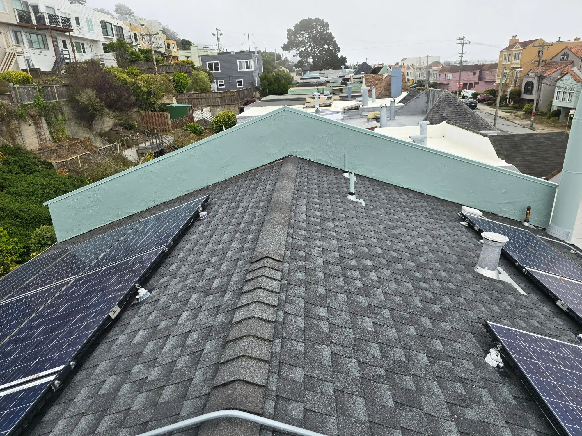 Solar panels installed on a residential roof with asphalt shingles.