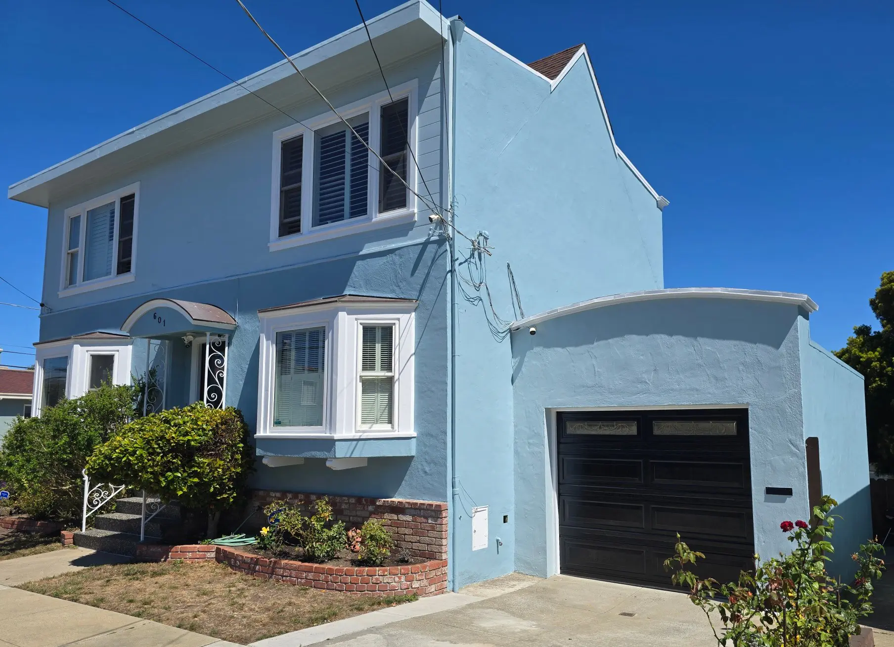 Blue two-story house with white trim and attached garage.