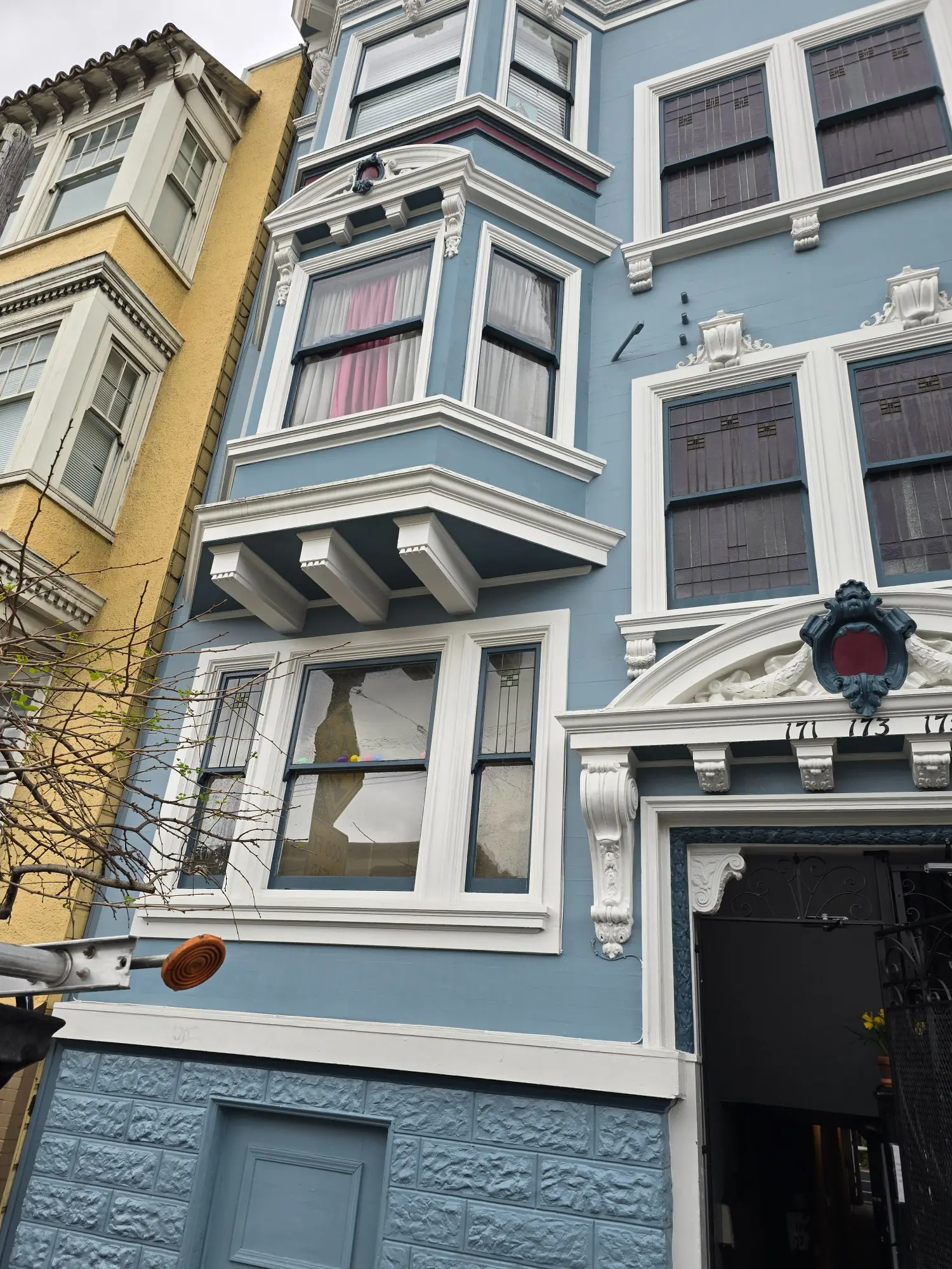 Colorful buildings with detailed architecture and a streetlight.
