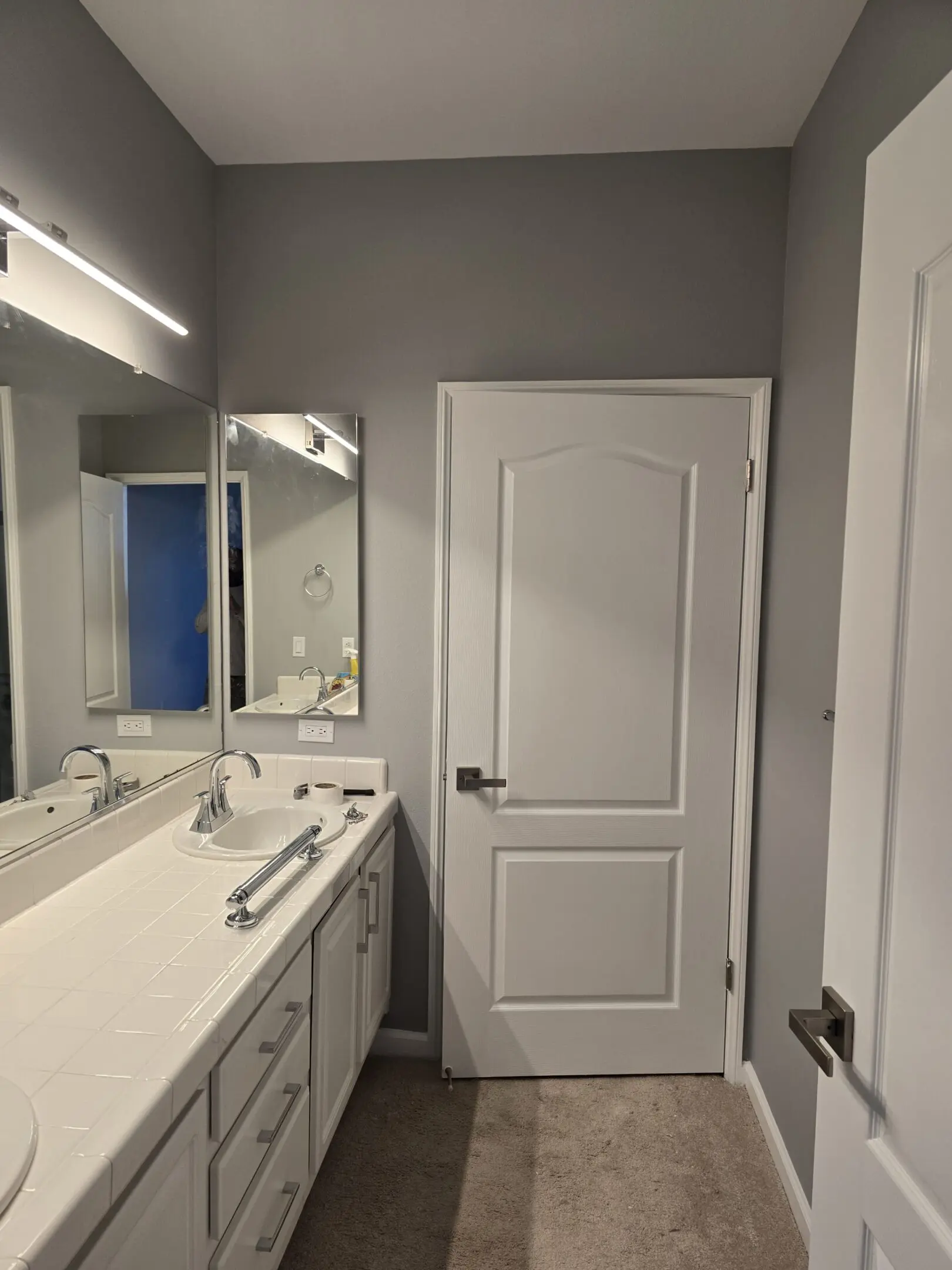 Modern bathroom with double sink and large mirror.