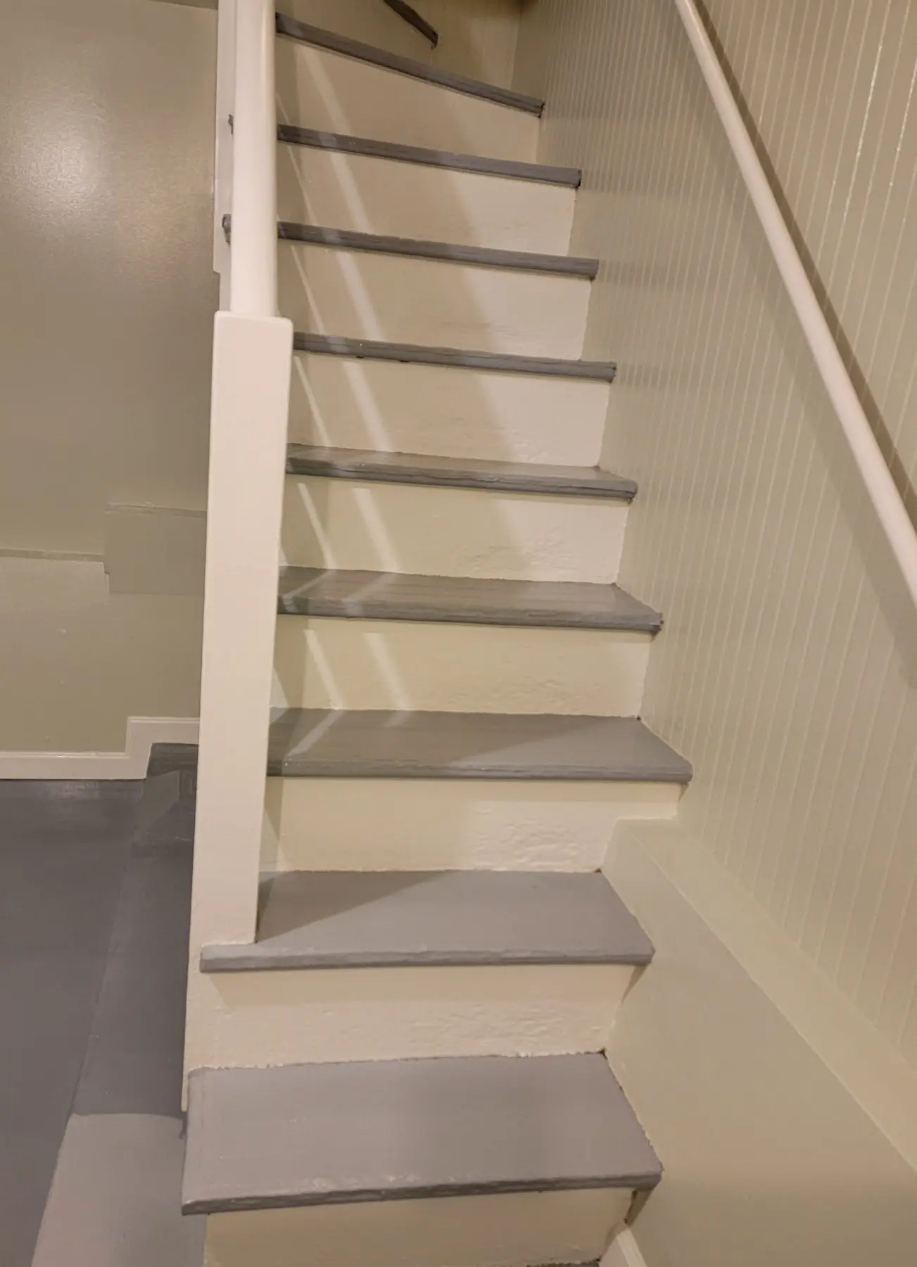 A modern staircase with light-colored steps and minimalist design.