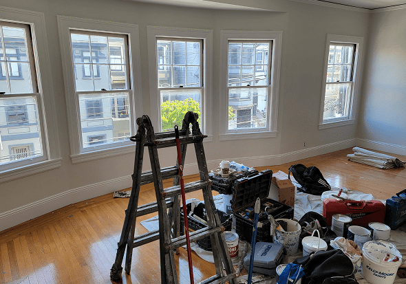 Room under renovation with painting supplies